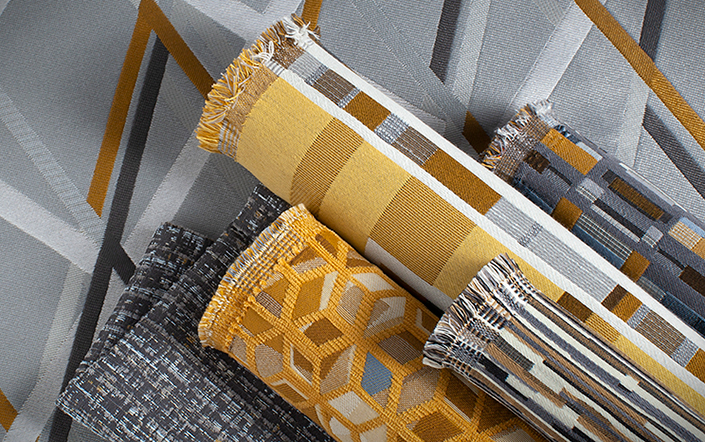 group of gold and gray fabrics with geometric patterns