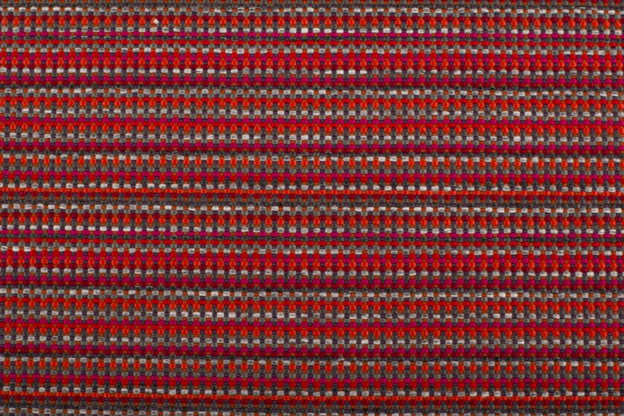 detail of linear upholstery textile in red and gray