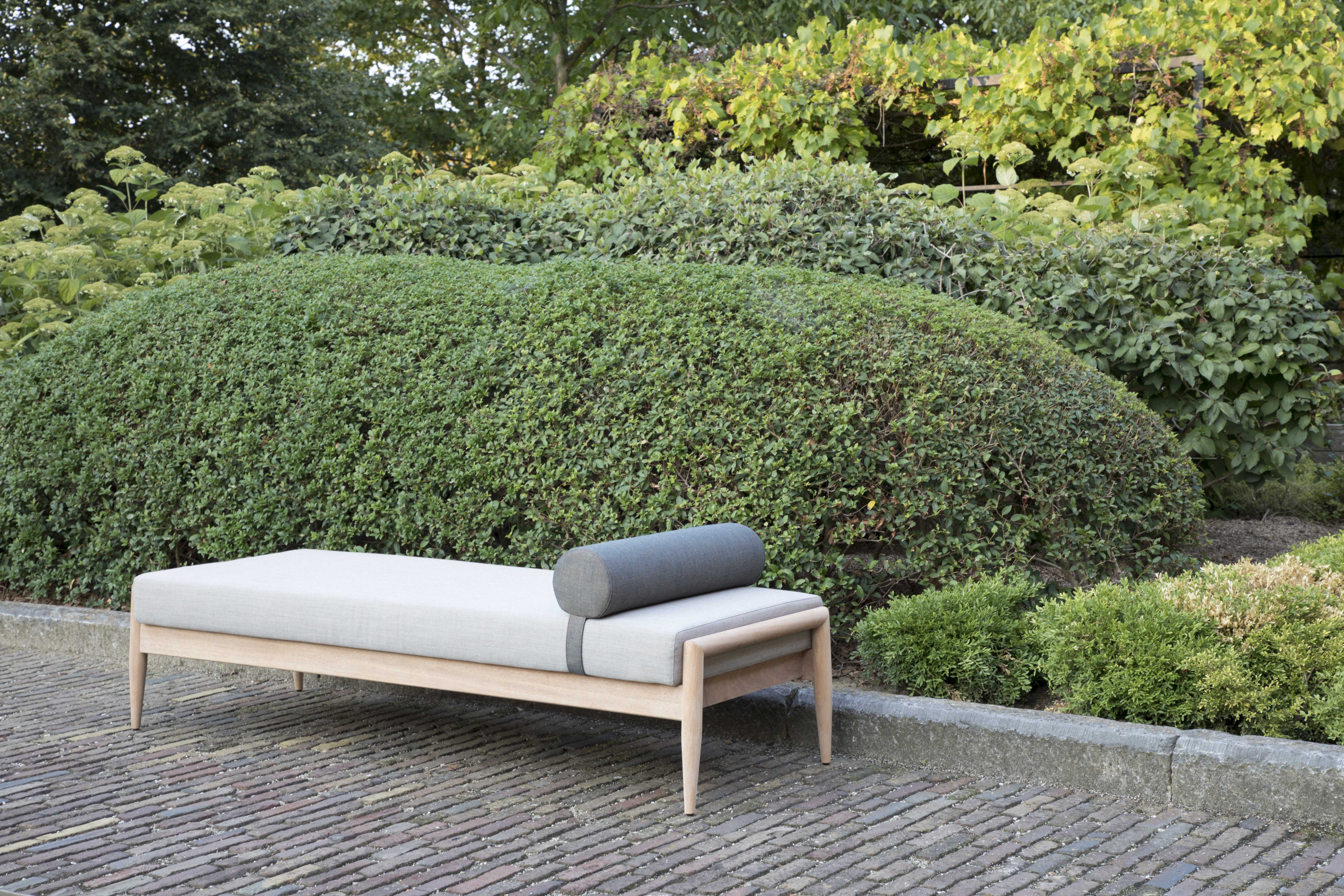 indoor-outdoor daybed with hardwood frame and gray upholstery