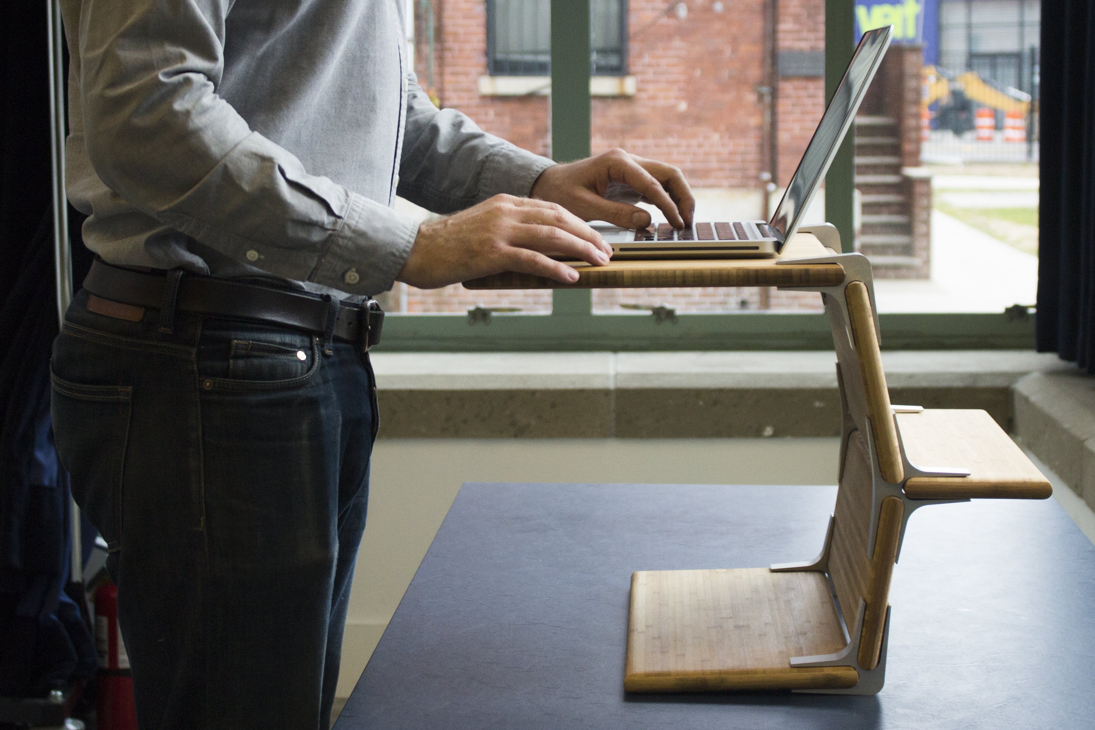 Modos Standing Desk side view with man using