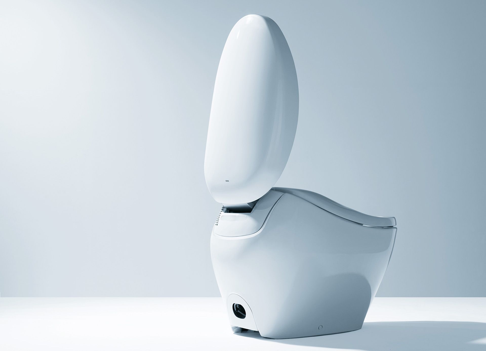 gleaming white toilet with skirted design and open lid