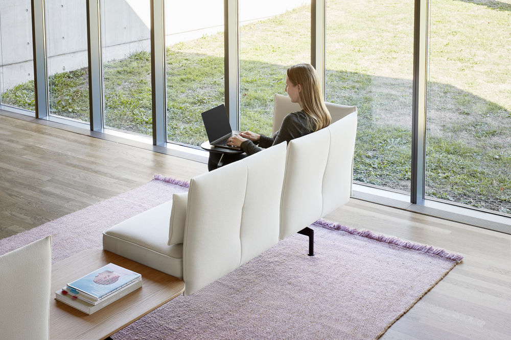 Vitra Soft Work view from behind with woman working and pink rug
