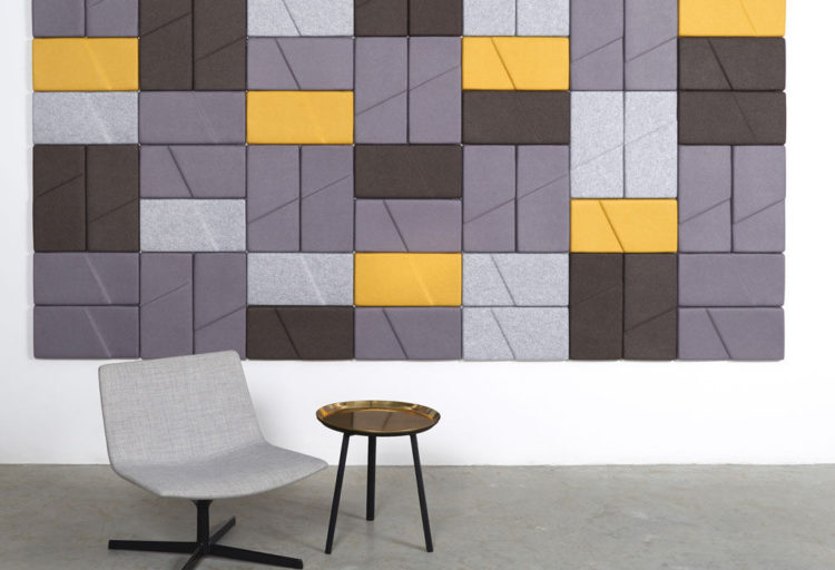 wall with rectangular acoustical tiles in gray and yellow