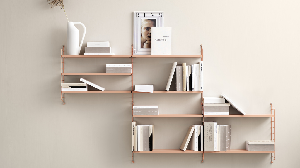 wall with pink metal shelving system