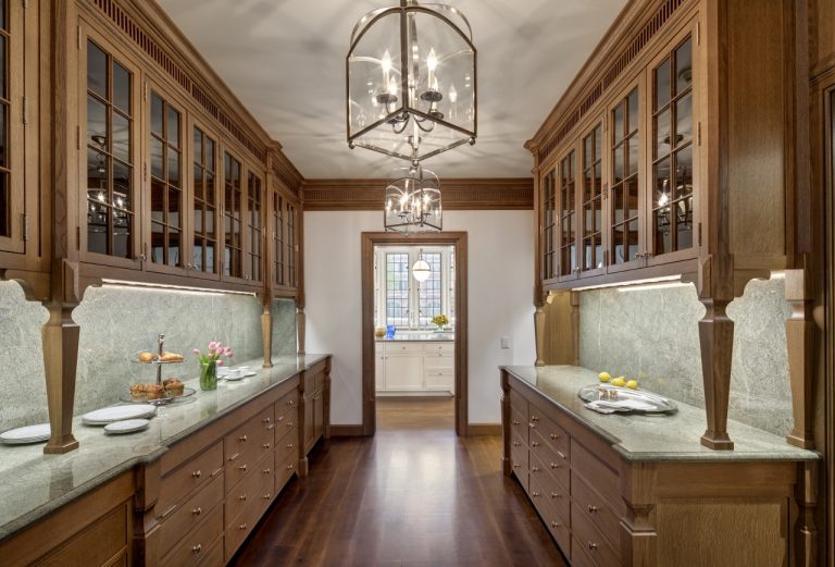 traditional butler's pantry with wood cabinets and wide plank wood flooring