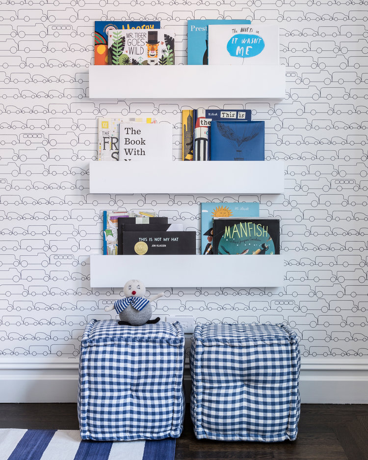 kids room with blue car wallpaper and floating shelves