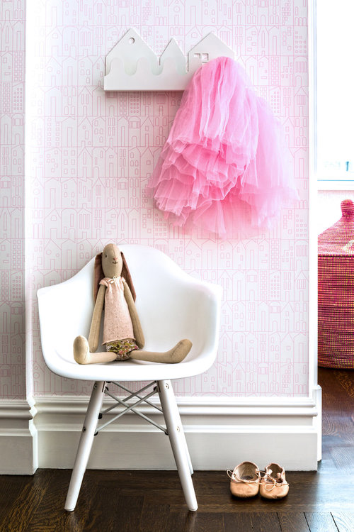 kids room with pink house wallpaper and tutu 