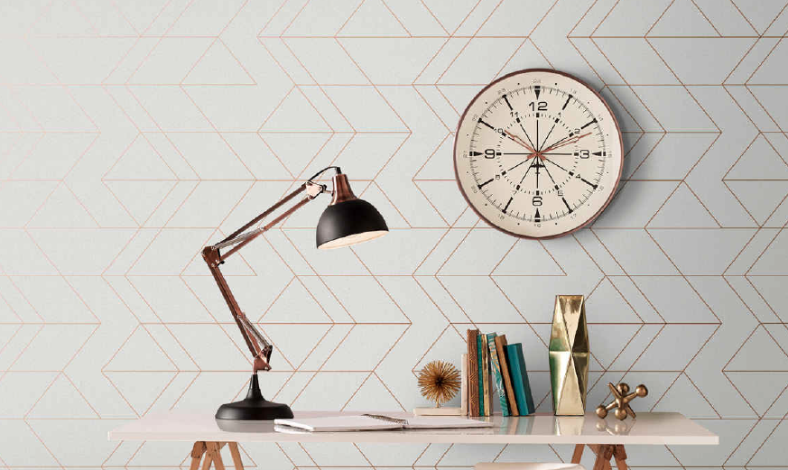 gray wallpaper with geometric gold pattern with clock and lamp visible