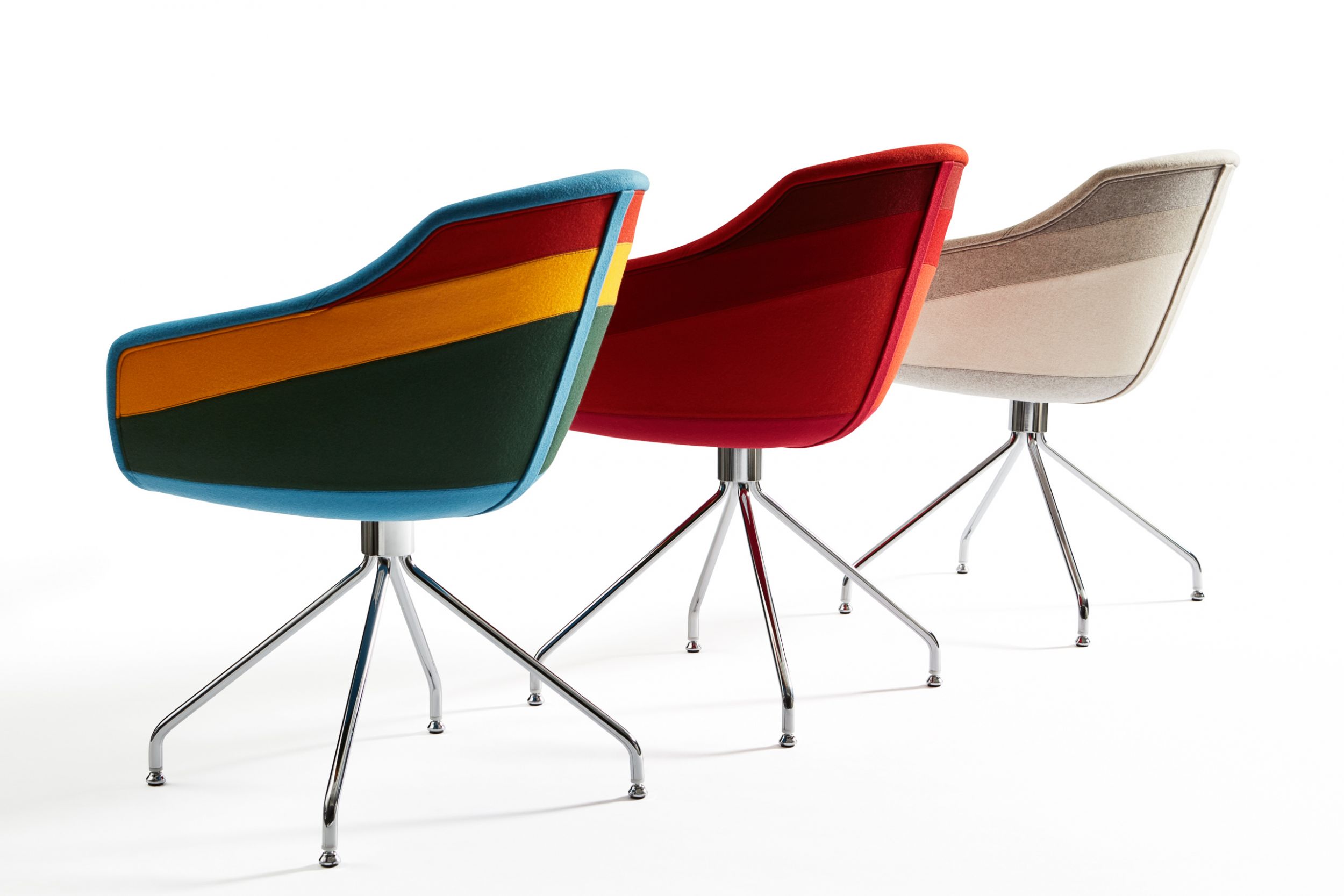 trio of brightly colored small armchairs with metal swivel bases