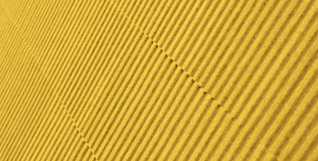 close-up view of yellow ribbed acoustical wool felt tile