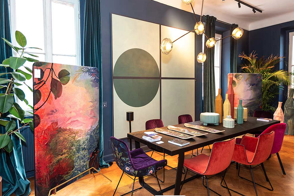 modern dining room with colorful velvet chairs and square of ceramic cladding on the wall