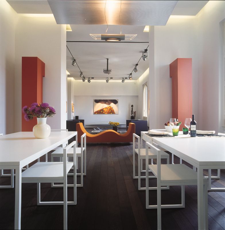 white restaurant with white metal tables and red accents