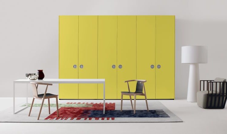 modern room with white metal table, chairs, and yellow storage