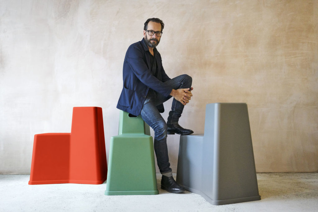 Konstantin Grcic image of designer atop the Stool-Tool stool