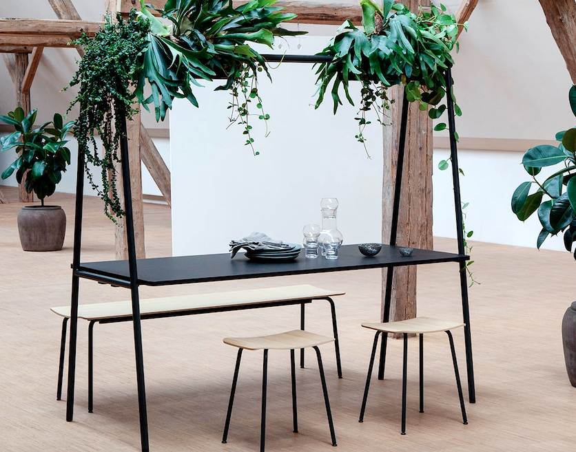 A-frame table in black metal with plants overhead