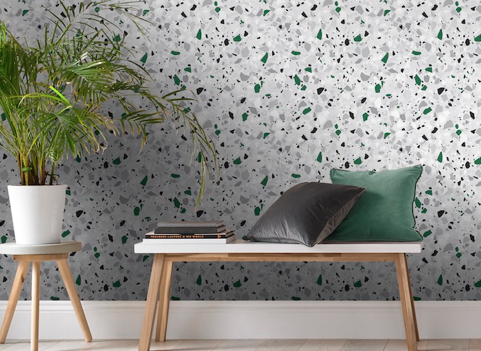 terrazzo-inspired wallpaper with green accent color in room with wooden bench