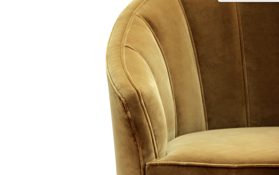 detail view of chartreuse velvet armchair with curved back