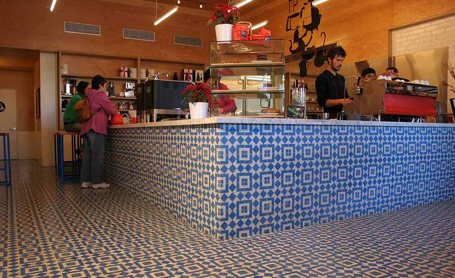coffee shop with blue and white geometric tile on floor and walls