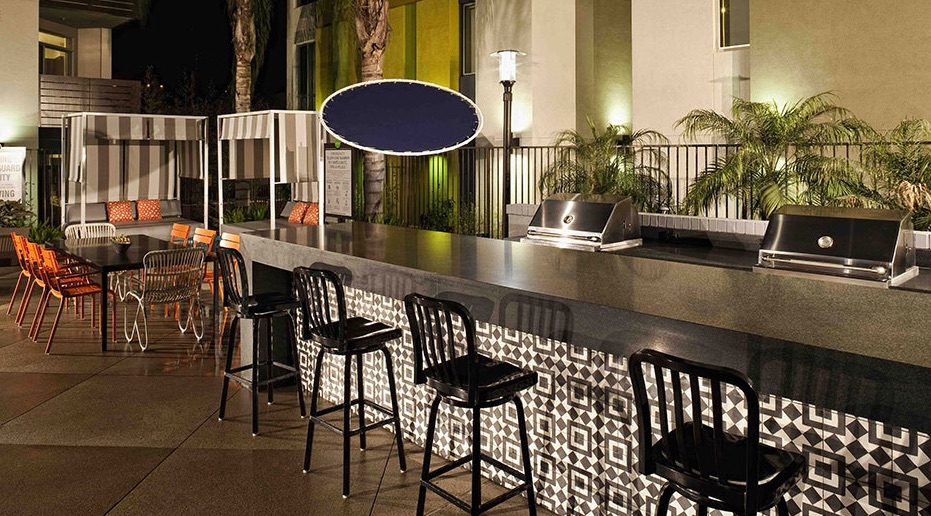 outdoor bar with black and white geometric tile on vertical surface