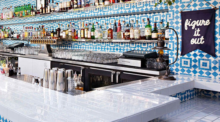 restaurant bar with blue and white geometric tile on wall