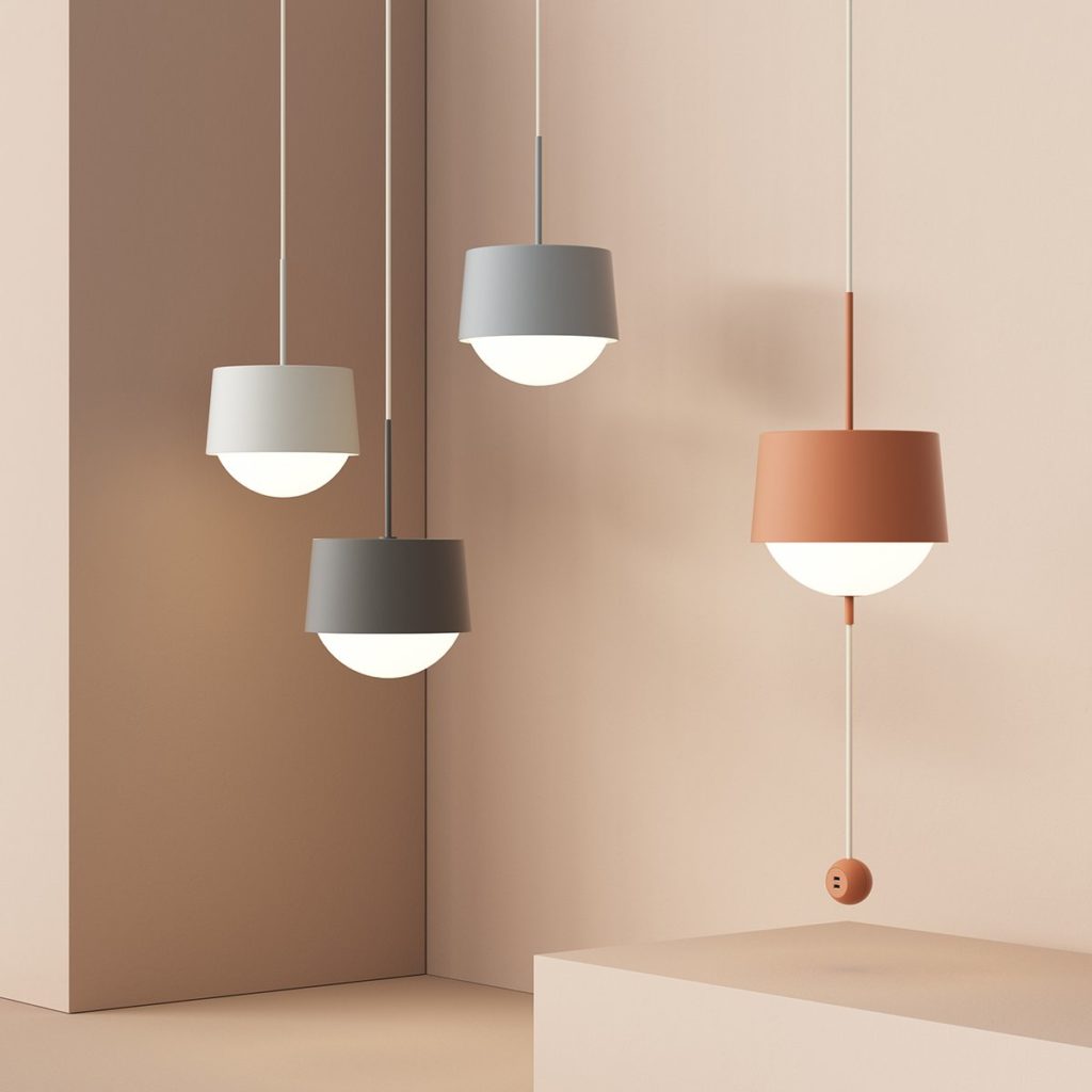 Four Most Modest Atlas Pendant lamps in shades of gray and orange in peach-colored room