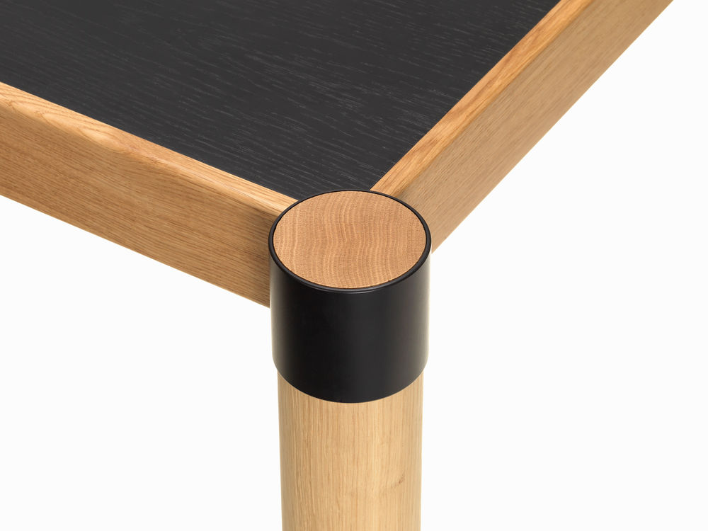 Vitra Cyl table detail of leg connector and black tabletop veneer