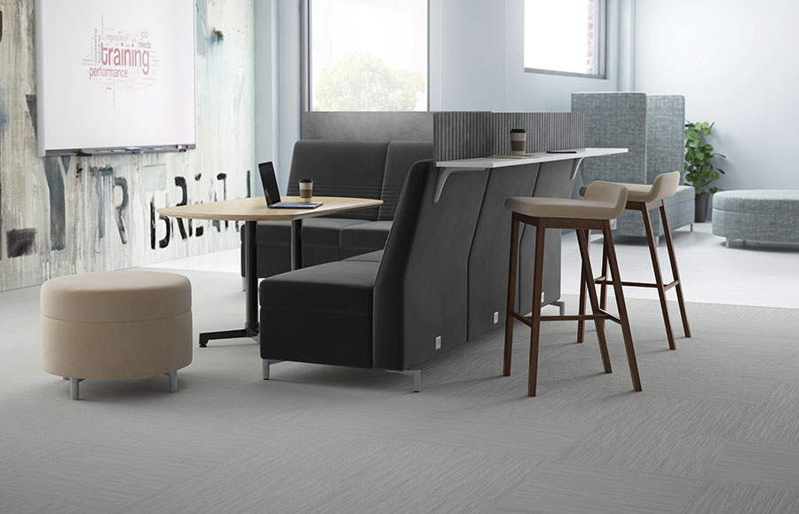 JSI Ziva stand-up work surface with privacy panel on back of gray lounge