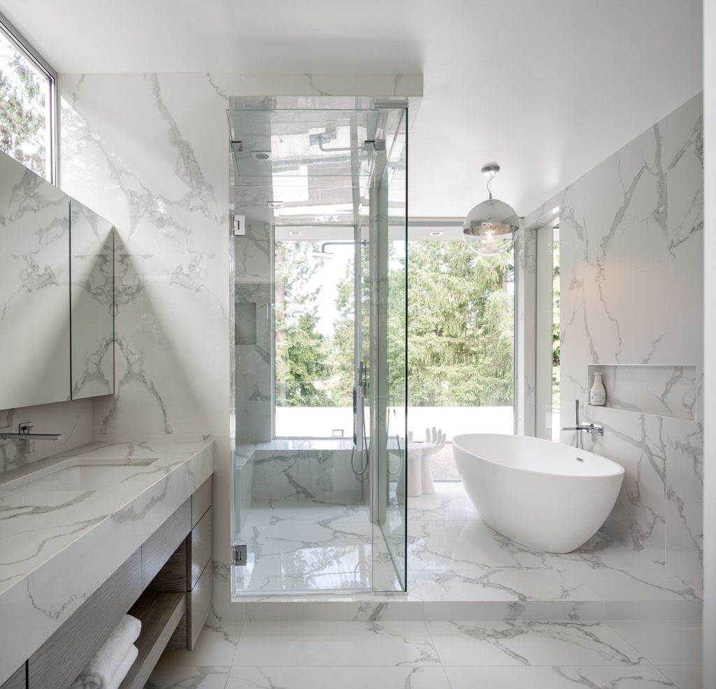 Fantini Mint Faucet in contemporary bathroom with glass shower and white porcelain bathtub