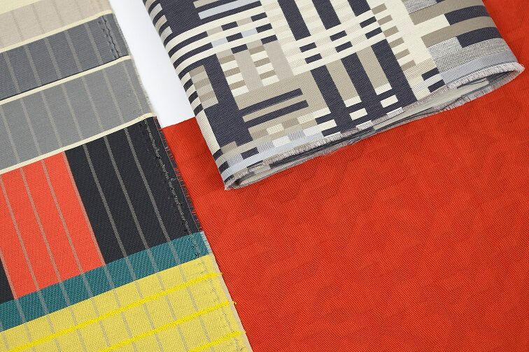 Designtex + Albers textile samples in many different colors against solid orange background