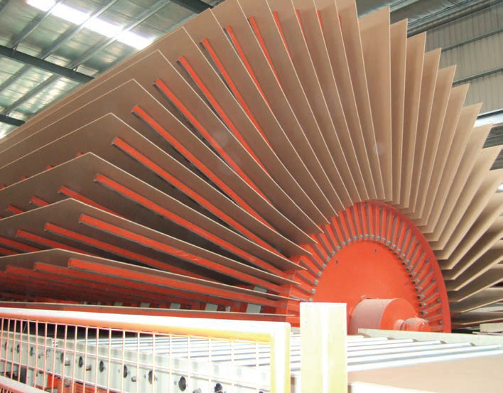 MDF sheet production at CalPlant. Image of large MDF roller with several sheets in half-moon shape