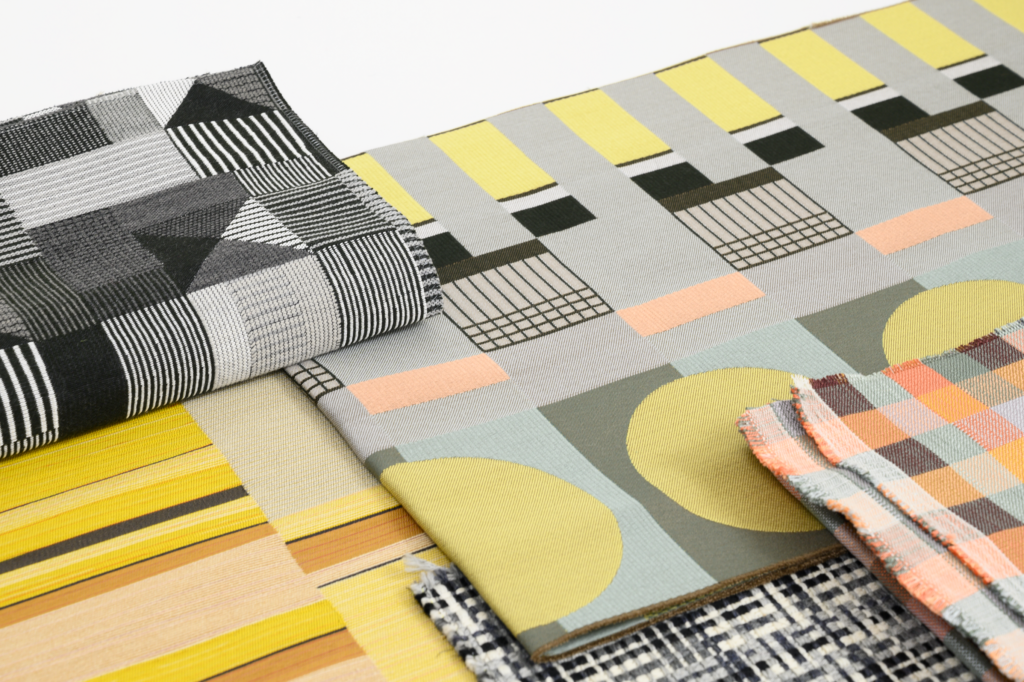 Designtex + Gunta Stölzl textile samples. Geometric forms in peach, yellow, black, and gray