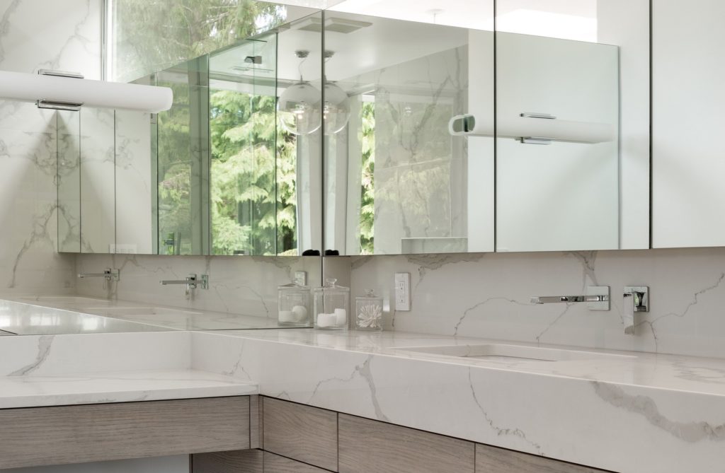 Fantini Mint Faucet in contemporary bathroom with white solid countertop