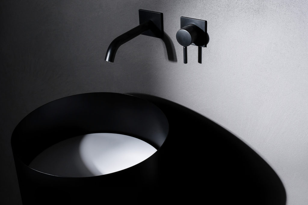 Atelier 12's Abisso Bathroom black sink with recessed white Cristalplant basin