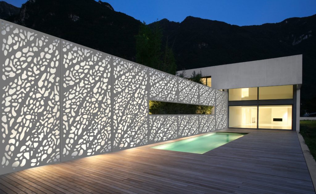Móz Backlit Metal Solutions illuminated wall next to swimming pool on outdoor deck