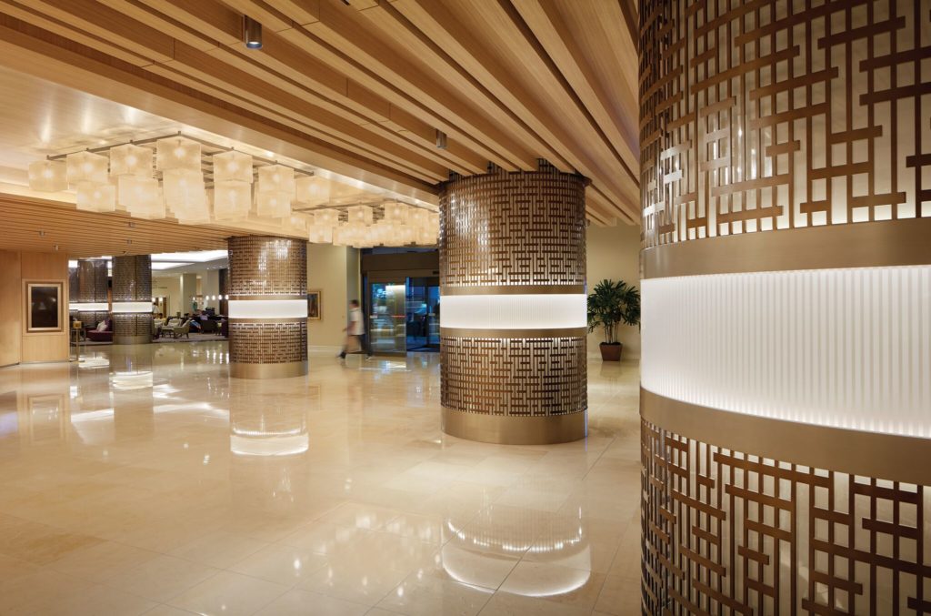 Móz Backlit Metal Solutions illuminated columns in Japanese gemoetrical motif in hotel lobby