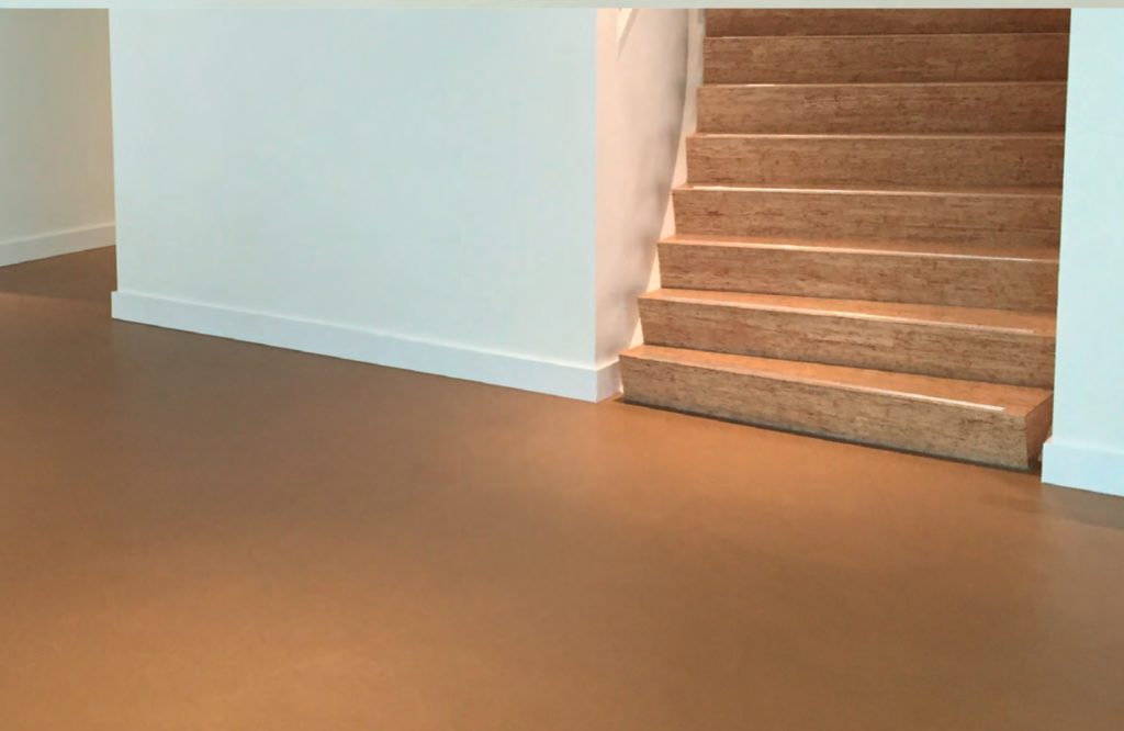 Corques Liquid Linoleum Province house rust colored floor with adjacent wooden stairs