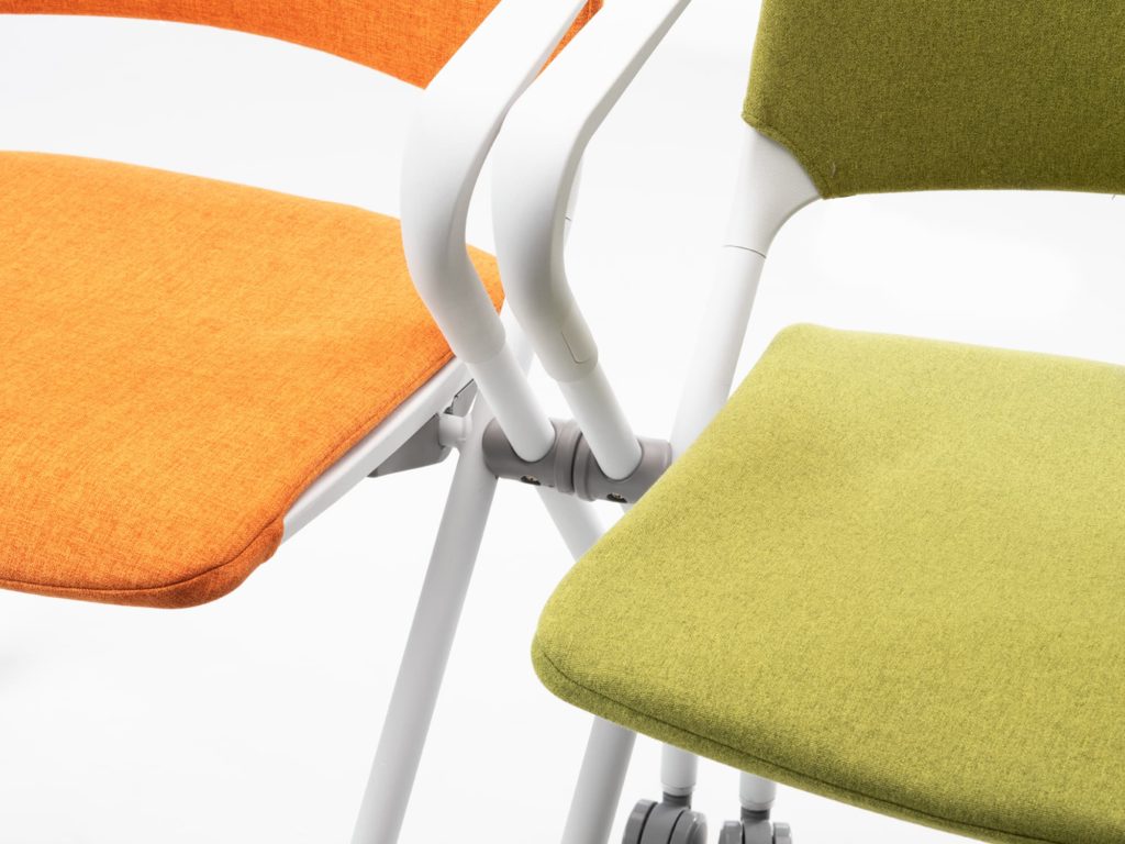 SitOnIt Qwiz Chair interlocking feature detail with two chairs orange upholstery on one green upholstery on other