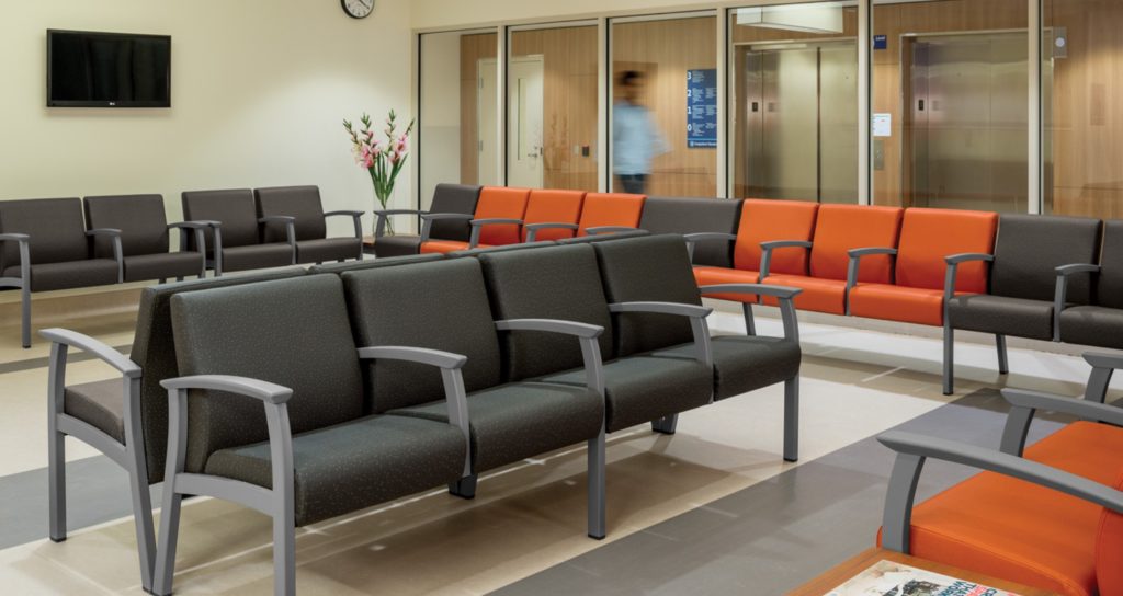 Primacare Seating in waiting room many chairs in ganged configuration charcoal and orange