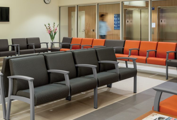 Primacare Seating in waiting room many chairs in ganged configuration charcoal and orange