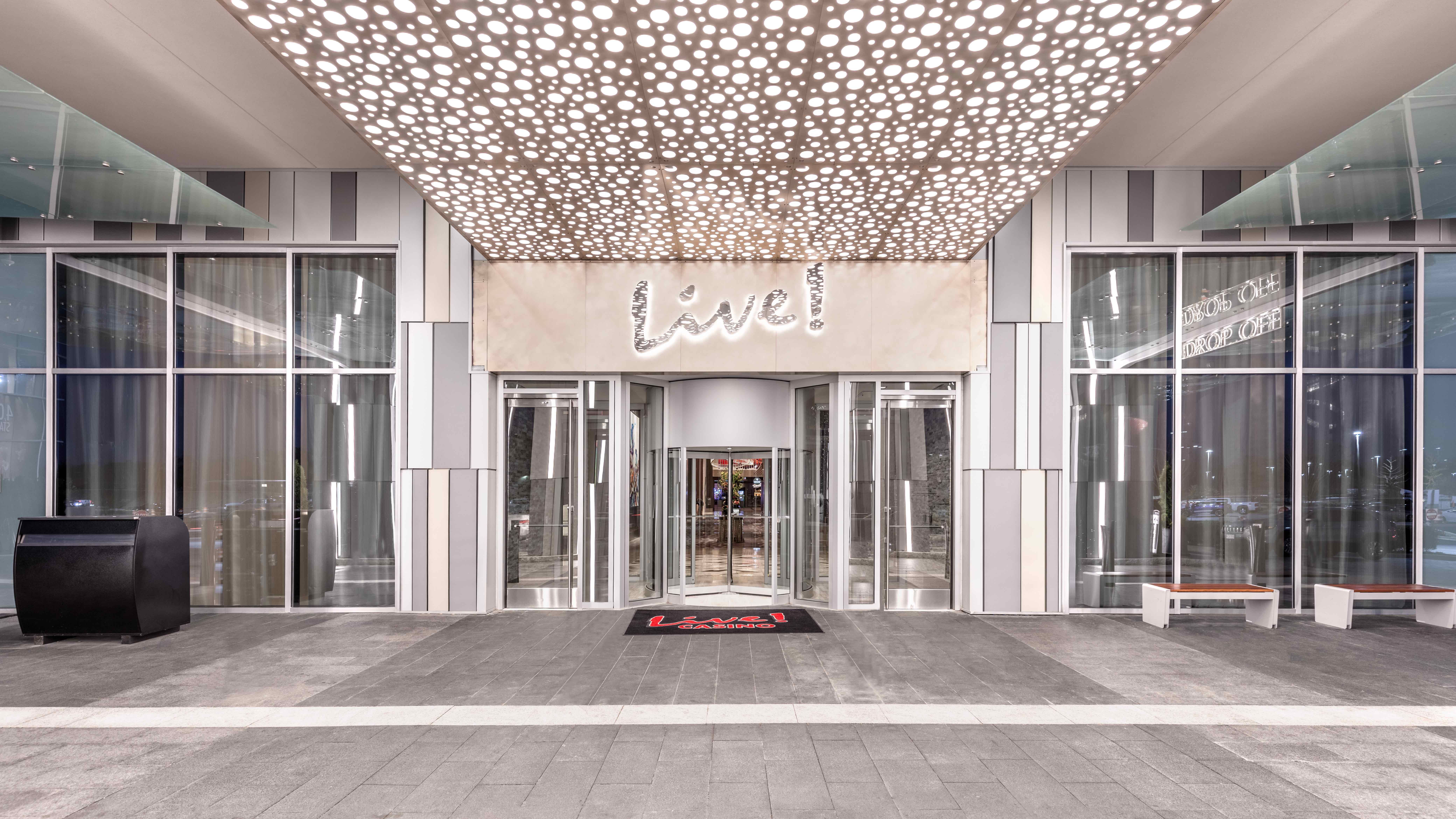 Móz Backlit Metal Solutions  illuminated ceiling panel in pattern of small circles above entrance to luxury hotel