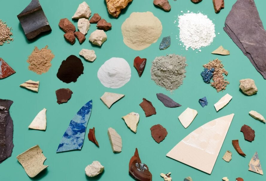 Granbyware raw materials shown in several different piles on green/blue background