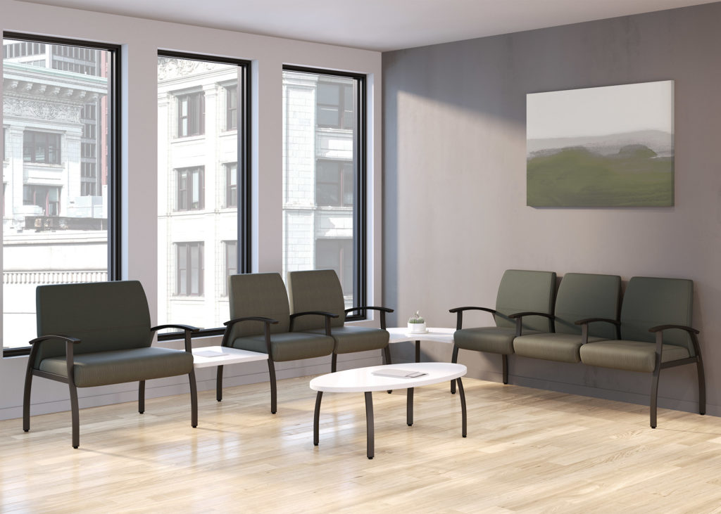 National Office Furniture Weli Seating ganged visitor chairs in olive upholstery with adjoining tables in white solid surface and center table in white solid surface in waiting room 