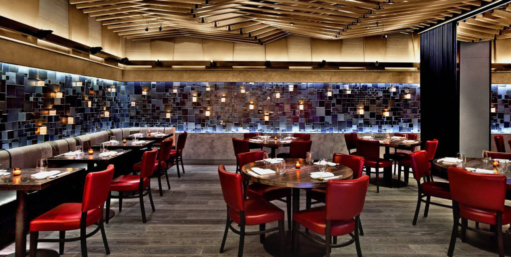 Demar Leather Nobu dining room with many tables and chairs in red leather