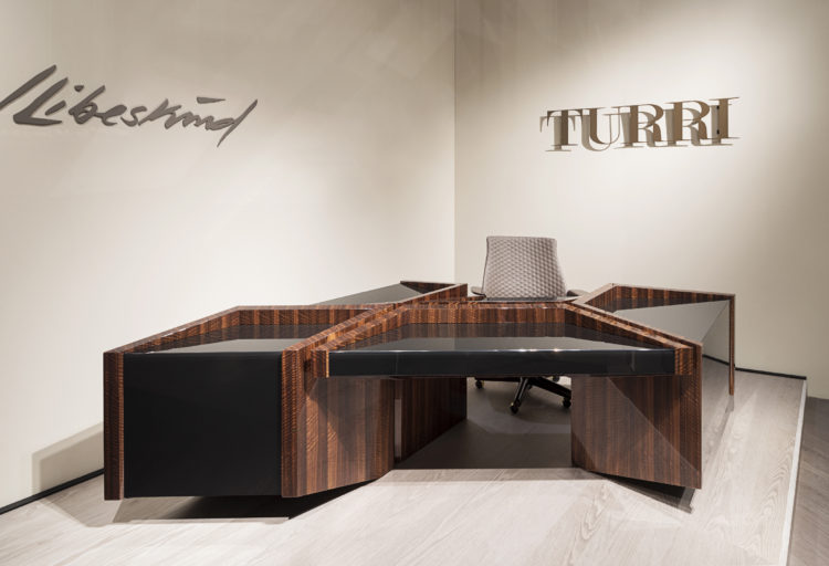 Edge Desk by Turri view from front with name of manufacturer and designer on wall behind