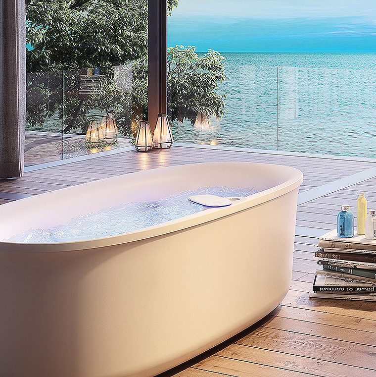 Jacuzzi's Arga bathtub in bathroom with wood floor overlooking ocean