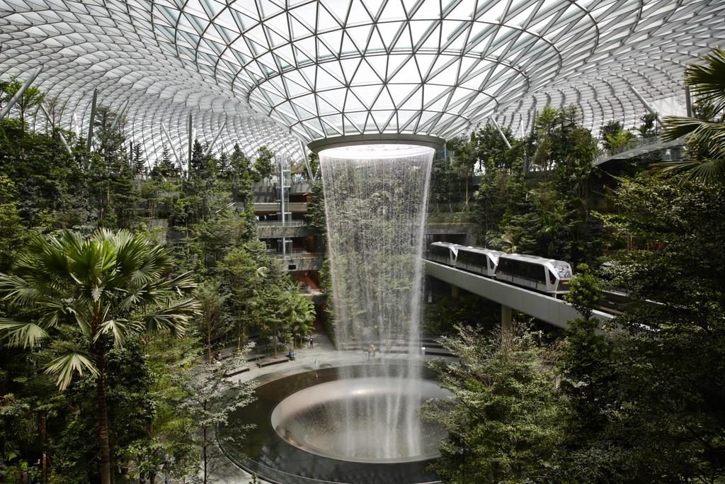 Vitro Architectural Glass in Jewel Changi Airport interior shot with gardens and close view of rain vortex with elevated train visible