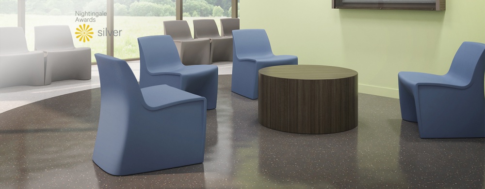 Hardi Children's nine chairs in blue, white, and gray in open room with circular coffee table