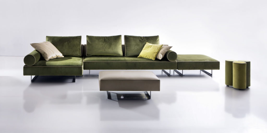 Nube Velvet Sofas Aline sofa with green upholstery and tan ottoman with large and small pillows
