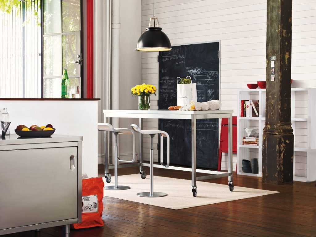 Titan Pendant in black in airy kitchen above white portable table with two high stools