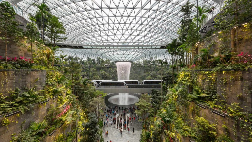 Vitro Architectural Glass in Jewel Changi Airport interior view with glass dome above, terraced gardens, and waterfall 